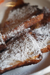 Sweet fried bread topped with powdered sugar served at breakfast