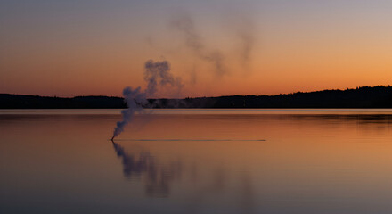 Mystical Lake at Twilight With A Rising Plume of Smoke