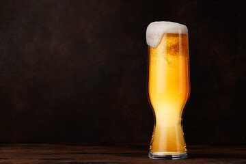 A glass of beer with a golden hue and frothy head