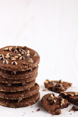 Chocolate Chip Cookies in a glass bowl and chocochips which is scattered under it
