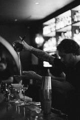 Bartender makes cocktails in a night bar
