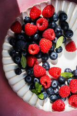 Closeup berries: strawberries, raspberries, blueberries in a plate