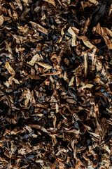 Pile of raw loose tobacco filing frame