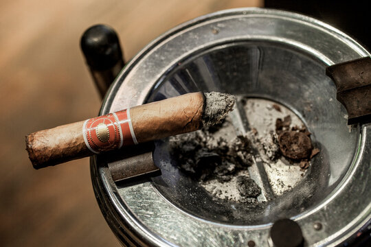 Lit cigar in ash tray looking down