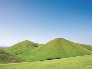 Green hills and mountains beneath a blue sky dotted with clouds create a scenic nature landscape