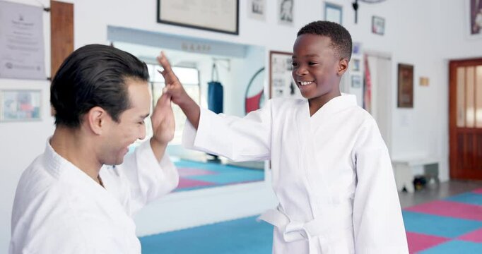 Man, teacher and high five with karate student in dojo for self defense training or preparation. Male person, sensei and mentor with kid, smile or belt for taekwondo practice, martial arts or start