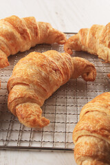 close up croissant french pastry on a rack