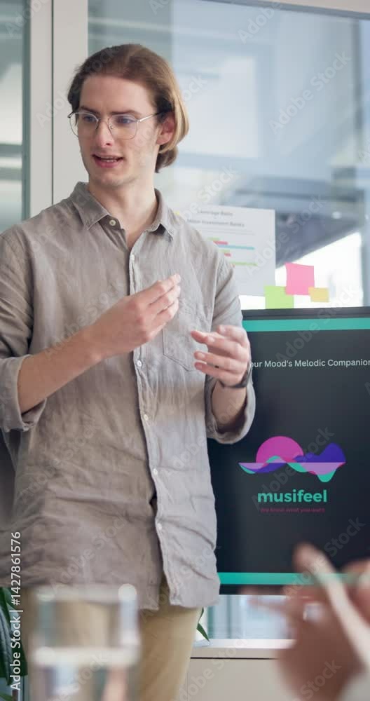 Poster Presentation, startup and business man in meeting for planning, music app prototype or project. Developers, sound search algorithm and discussion with person in office for programmer pitch and screen