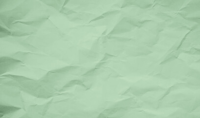 Crumpled piece of green paper grunge background. Recycled craft paper texture background.