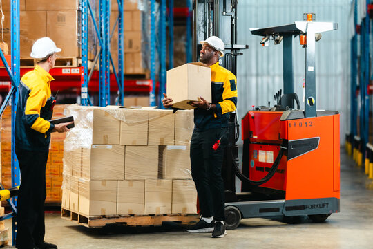 Warehouse Workers Loading Forklift.