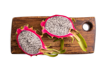 Ripe Pitaya on cutting board isolated on white, top view, close up