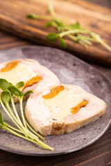Chicken, egg and dried apricot meatloaf, microgreen on brown wooden. Diet, healthy eating. side view, selective focus