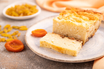 Сottage cheese Сasserole, Curd cake, with dried apricots and raisins on brown concrete, side view, selective focus