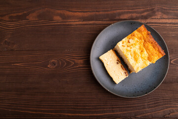 Сottage cheese Сasserole, Curd cake, with dried apricots and raisins on brown wooden, top view, copy space