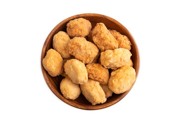 Fried crispy Chicken Nuggets in brown wooden bowl isolated on white. top view