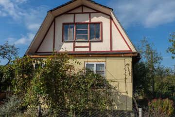 A small country house on a summer street.