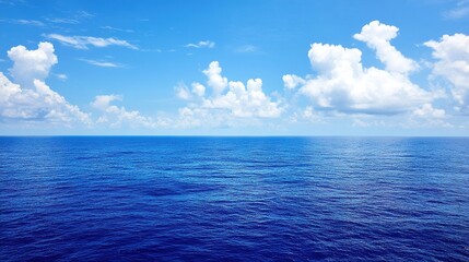 Fototapeta premium A serene ocean view under a clear blue sky, with vibrant azure waters extending to the horizon. The bright, inviting color palette is ideal for serenity and relaxation themes.