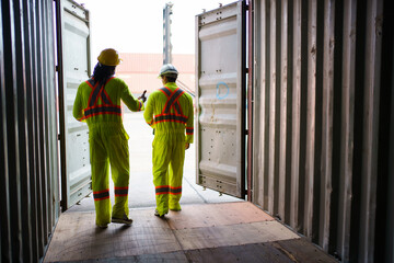 Engineers team or shipyard officers inspecting a containers in container yard.