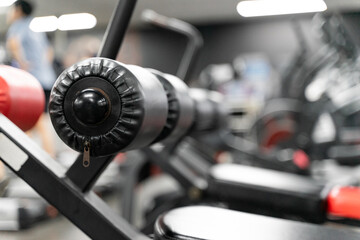 Fototapeta premium sstkWellness captures the essence of modern fitness with this striking image of a mechanical strength training machine loaded with weight plates, highlighting the synergy between structured physical