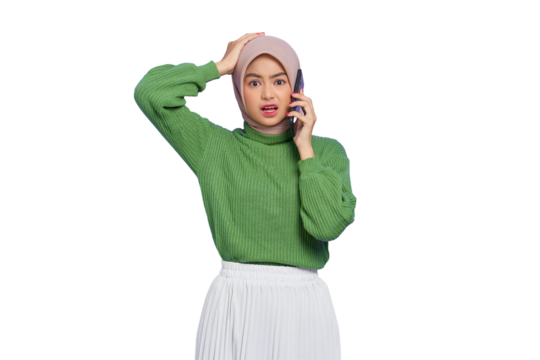 Shocked beautiful Asian woman in green sweater talking on mobile phone with open mouth isolated on transparent background