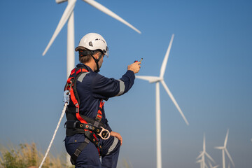 Naklejka premium Engineer man working at windmill farm Generating electricity clean energy. Wind turbine farm generator by alternative green energy.