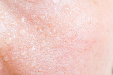 Fototapeta premium Close-up of a woman's face sweating in the hot summer