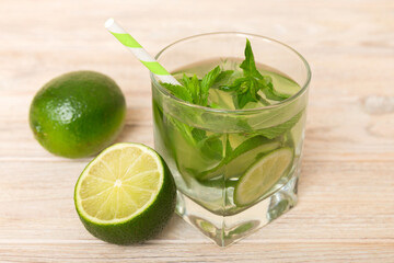 Mojito cocktail. Refreshing mojito cocktail with lime, lemon and mint in a tall glass with a stick