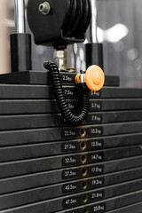 sstkWellness showcases the structure and precision of strength training through this image of a pin-loaded weight machine, designed for both safety and performance. This type of resistance equipment