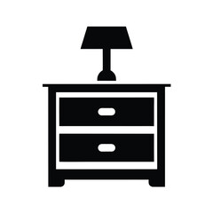 Silhouette of a drawer, a lamp, and a book on top