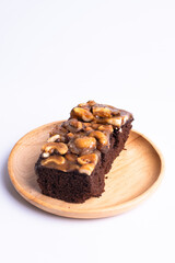 Cashew toffee cake in wood plate on white background