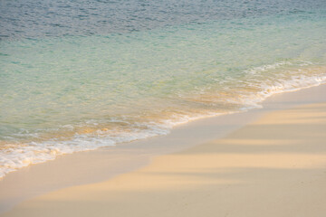 Nature of the beach and sea Summer with sunshine, sandy beaches, clear blue waters sparkling against the blue sky. On an island with good ecology and environment Background for summer vacation