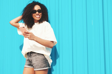 Beautiful  woman with afro curls hairstyle.Smiling hipster model in white t-shirt. Sexy carefree...