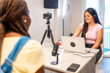 Teenage girls recording podcast or video blog at home