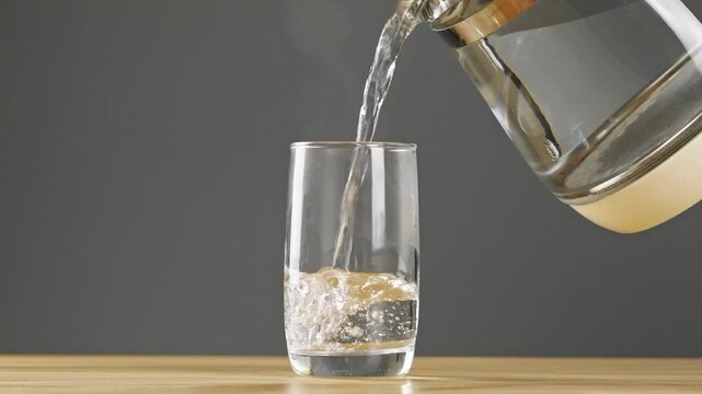 pouring hot water into glass