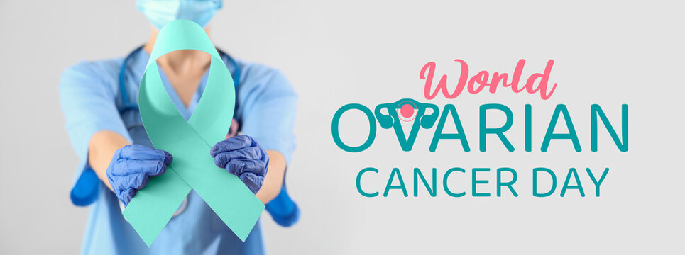 Female doctor with pink ribbon on light background, closeup. Breast cancer awareness concept