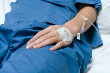 The saline tube on the left hand of the patient is giving the saline solution that lies in the hospital bed