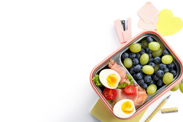 Lunchbox with delicious food and stationery isolated on white background