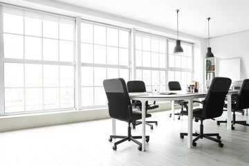 Interior of modern office with table prepared for meeting