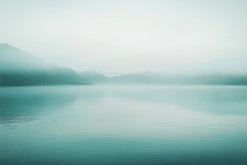 Obraz premium Misty lake landscape. Tranquil, serene, and peaceful mountain view