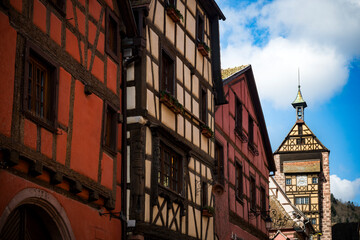 Charming medieval street with tower in Riquewihr in Alsace, France
