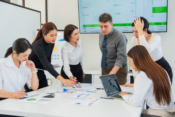 Group of business people are having a meeting and looking stressed about the work they are trying to solve.