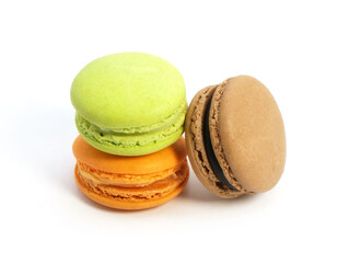 Pile of macaron cookies in various flavours and colours isolated on white background.