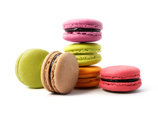 Pile of macaron cookies in various flavours and colours isolated on white background.