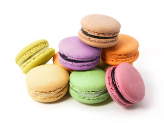 Pile of macaron cookies in various flavours and colours isolated on white background.