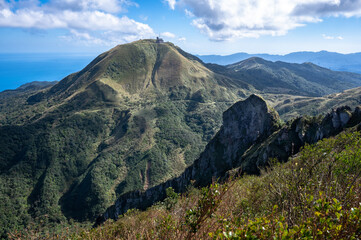 Cao Shan mountain in the cloudy day, sunlight shines between the cloud, in New Taipei City, Taiwan.