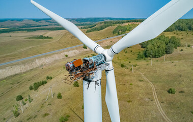 Aerial shot of wind turbine with fire damage in a rural landscape during the daytime © Evgenii Bakhchev