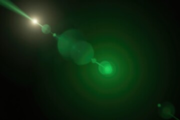 Lens flare with a single green light source on black background, sunbeam, photography