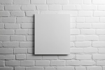 Empty square canvas on white brick wall