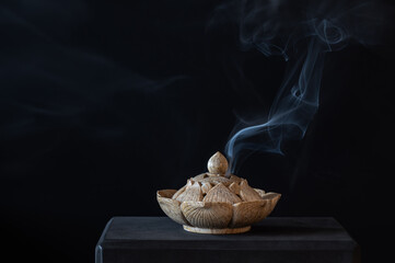 Stone carved incense burner on a black background.