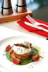 a plate of salmon pesto with dry chilli on top as the garnish